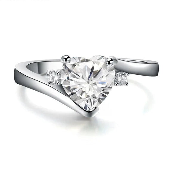 Silver ring with a heart-shaped diamond on a white background, featuring the brand 'Jun Xin'.