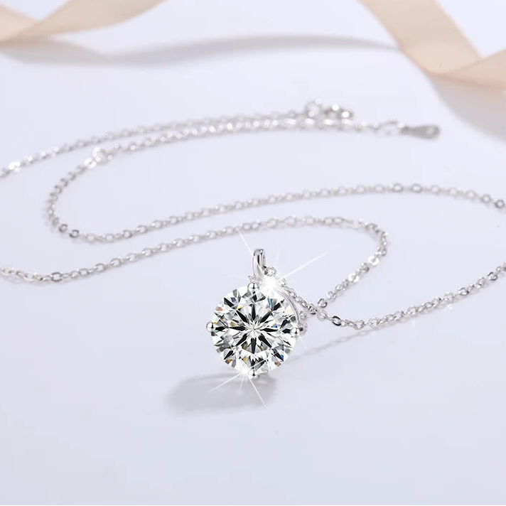 Silver necklace with a diamond pendant on a white background, featuring the brand 'CODERIA'.