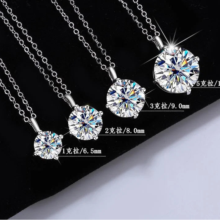 Diamond pendants on a chain with size measurements against a black and white background