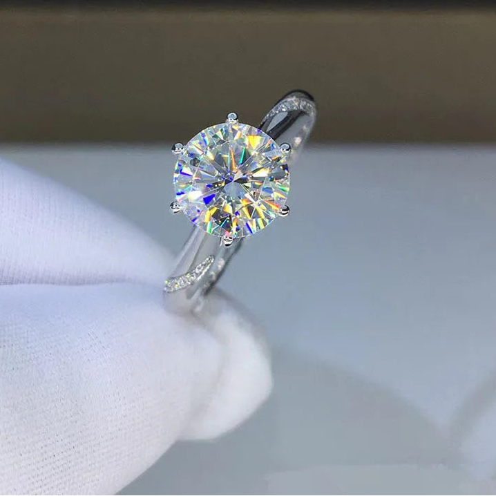 Diamond ring on a white cushion with 'CODERIA' branding in the background
