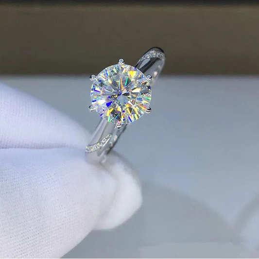 Diamond ring on a white cushion with 'CODERIA' branding in the background