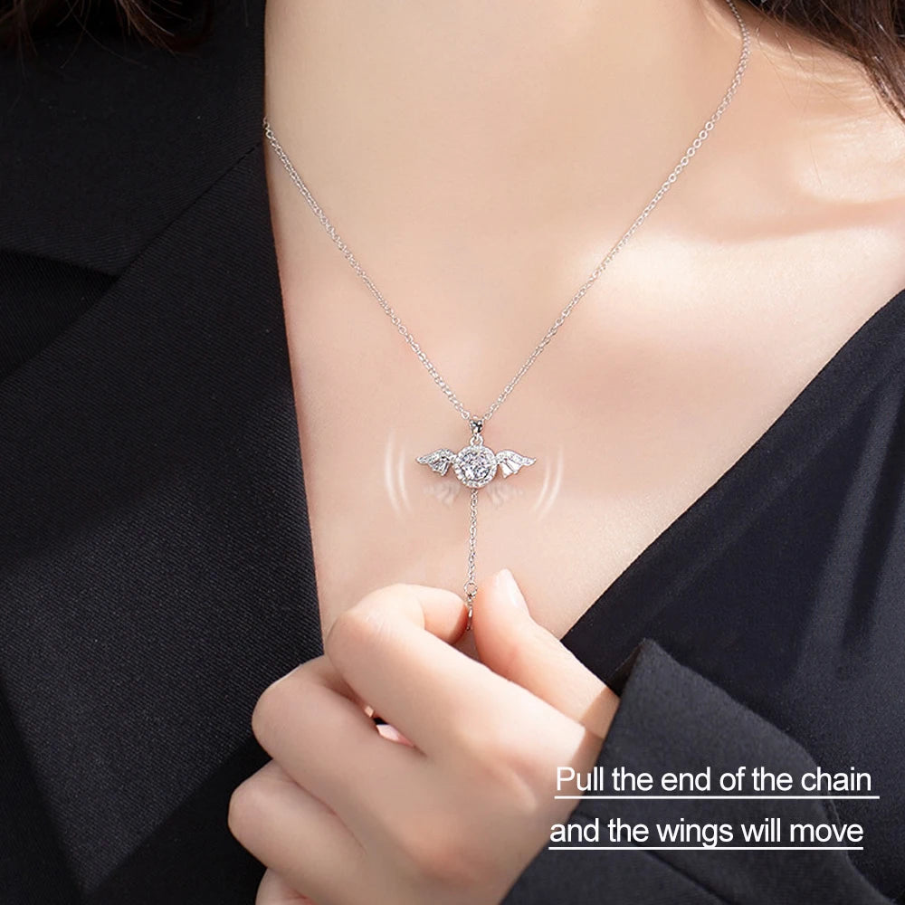 Necklace with a winged pendant worn by a person, with text indicating a unique feature of the necklace.