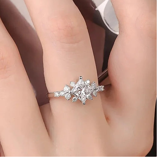 Diamond ring on a finger with Coderia branding and 'Real Sterling 925' stamp.