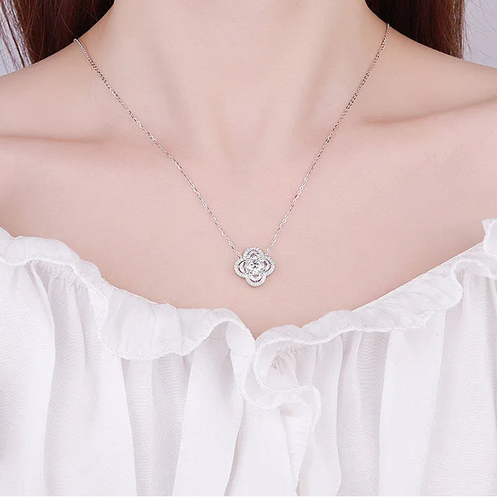 Silver necklace with a floral pendant on a mannequin wearing a white blouse, branded 'CODERIA'.