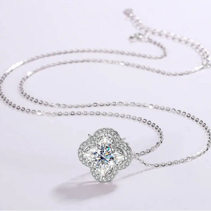 Silver necklace with a floral pendant on a light gray background, featuring the brand 'CODERIA'.