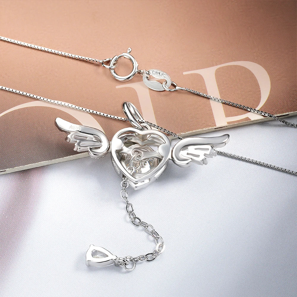 Silver necklace with a heart and wings pendant on a light background